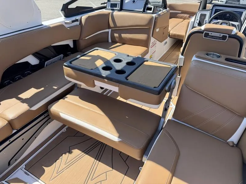 Slide: The Image of 2023 Supra SA boat interior with tan leather seating and a central table. - 11