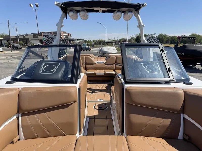 Slide: The Image of 2023 Supra SA boat interior with tan leather seating and open windshield. - 14