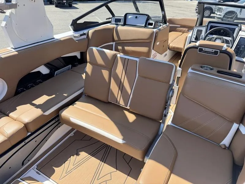 Slide: The Image of 2023 Supra SA boat interior with luxurious tan seating and modern dashboard design. - 16