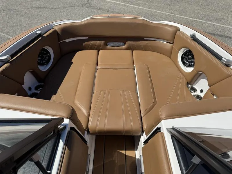 Slide: The Image of 2023 Supra SA boat interior with tan leather seating and built-in speakers. - 17