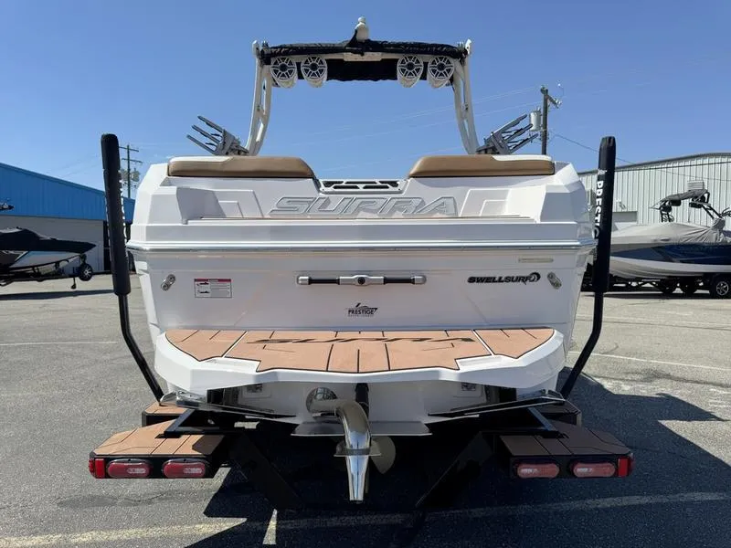 Slide: The Image of 2023 Supra SA boat rear view with wakeboard tower and swim platform. - 4