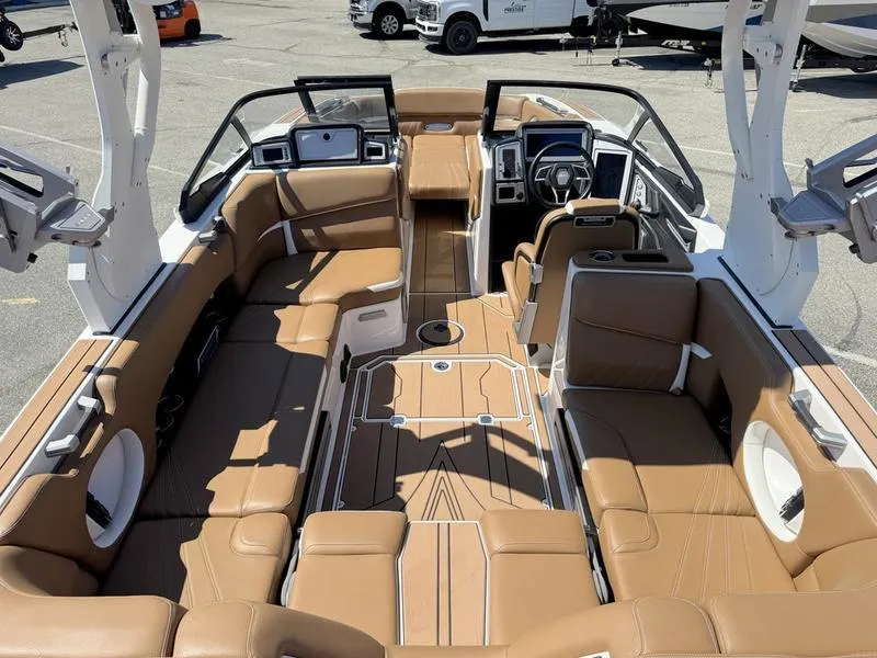Slide: The Image of 2023 Supra SA boat interior with luxurious tan seating and modern dashboard design. - 5
