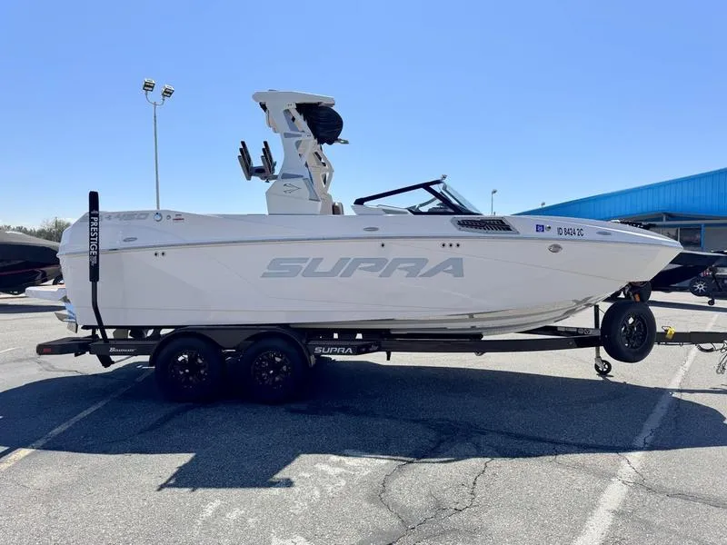 Slide: The Image of 2023 Supra SA boat on trailer in parking lot, side view. - 8
