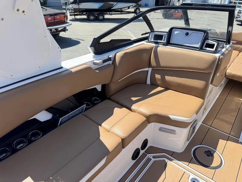 Slide: The Image of 2023 Supra SA boat interior with tan leather seating and modern dashboard. - 9