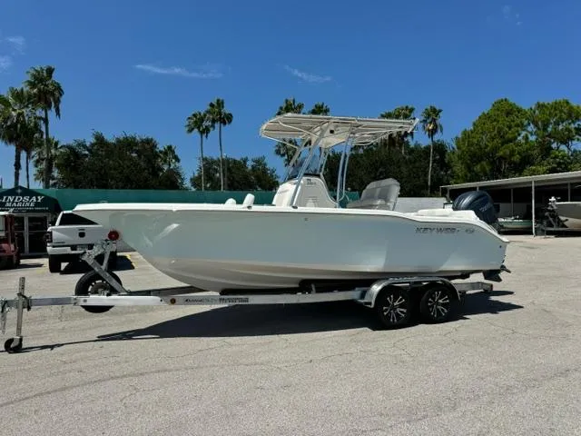The Image of 2026 Key West 219 FS boat on trailer, parked outdoors under clear blue sky. - 1