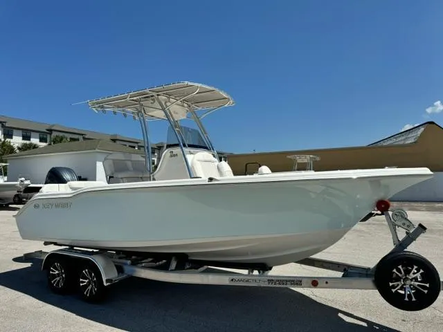 Slide: The Image of 2026 Key West 219 FS boat on trailer under clear blue sky. - 3