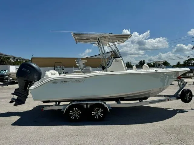 Slide: The Image of 2026 Key West 219 FS boat on trailer under clear blue sky. - 6