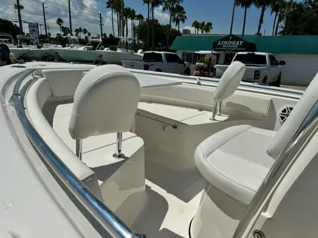 Slide: The Image of 2026 Key West 219 FS boat interior with white seating and chrome railings. - 8