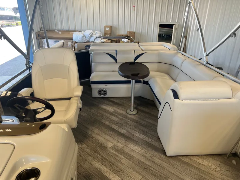 Slide: The Image of Interior of 2018 Berkshire 23 CLSTS2.75 pontoon boat with white seating and wood flooring. - 10