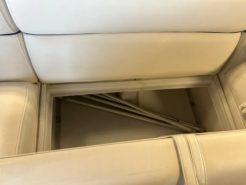 Slide: The Image of Storage compartment in 2018 Berkshire 23 CLSTS2.75 boat with beige seating. - 12