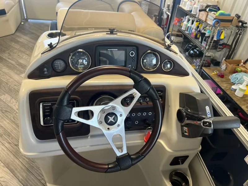Slide: The Image of Steering console of a 2018 Berkshire 23 CLSTS2.75 boat with gauges and controls. - 13