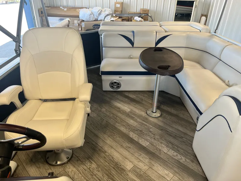 Slide: The Image of Interior of 2018 Berkshire 23 CLSTS2.75 boat with white seating and wood flooring. - 14