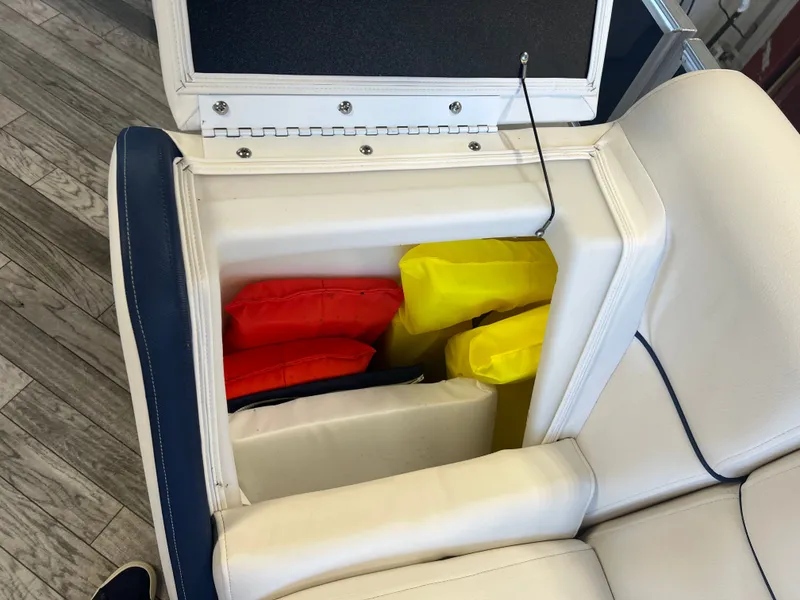 Slide: The Image of Open storage compartment on 2018 Berkshire 23 CLSTS2.75 boat with colorful life jackets. - 17