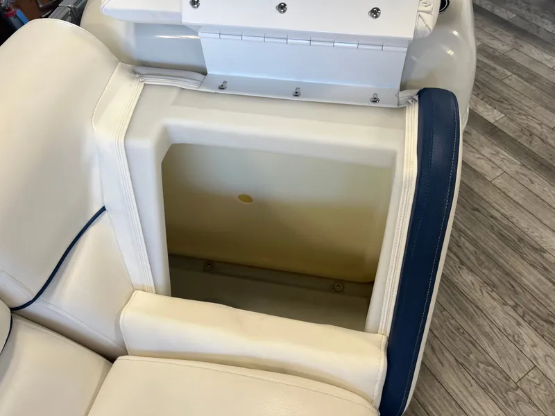 Slide: The Image of Open storage compartment in 2018 Berkshire 23 CLSTS2.75 boat with white and blue seating. - 18