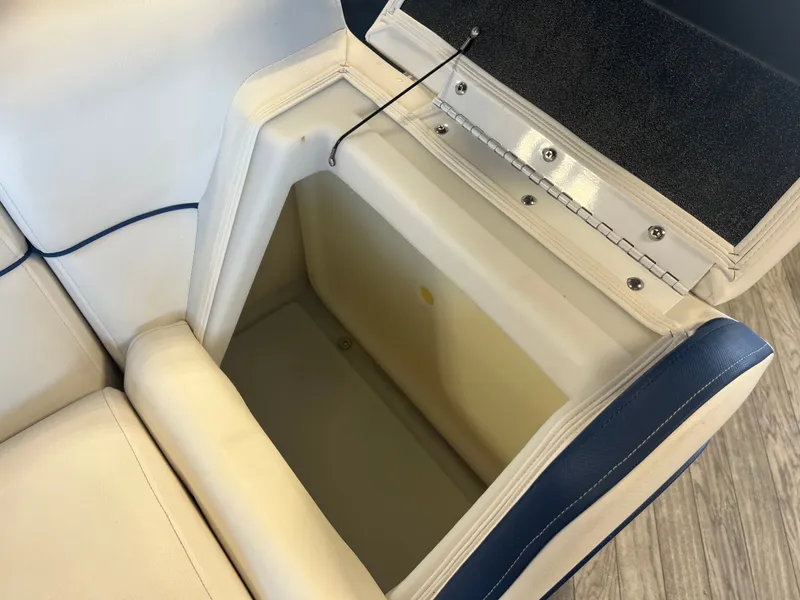 Slide: The Image of Open storage compartment in 2018 Berkshire 23 CLSTS2.75 boat seat, featuring white and blue upholstery. - 19