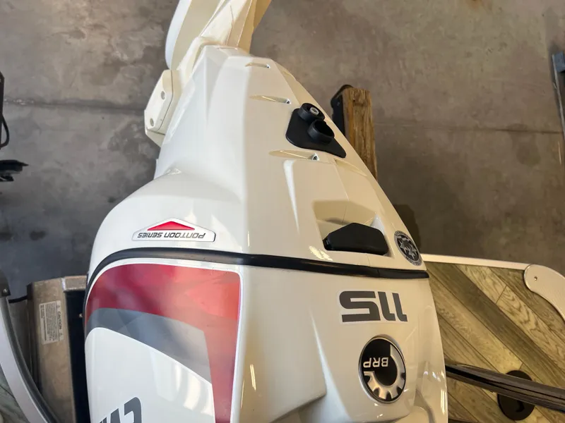 Slide: The Image of 2018 Berkshire 23 CLSTS2.75 boat engine, white with red accents, in a garage setting. - 20