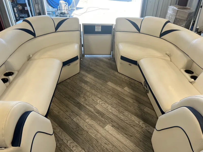 Slide: The Image of Interior of a 2018 Berkshire 23 CLSTS2.75 pontoon boat with white seating and wood flooring. - 6