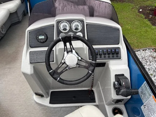 Slide: The Image of 2021 Sylvan Mirage 820 Cruise dashboard with steering wheel and control panel. - 11