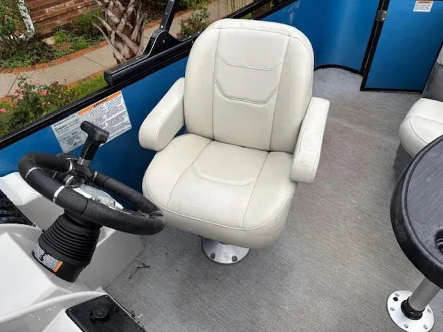 Slide: The Image of Captain's chair and steering wheel in 2021 Sylvan Mirage 820 Cruise boat interior. - 12