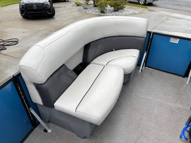 Slide: The Image of 2021 Sylvan Mirage 820 Cruise boat with curved seating and blue paneling. - 16