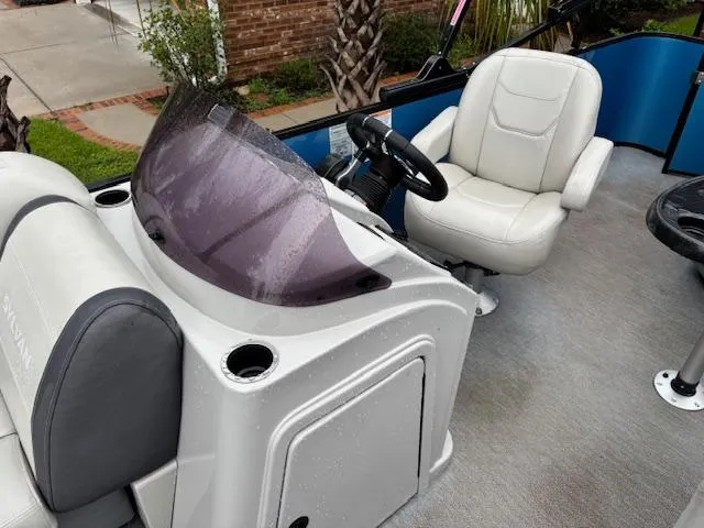 Slide: The Image of 2021 Sylvan Mirage 820 Cruise boat interior with steering console and seating. - 19