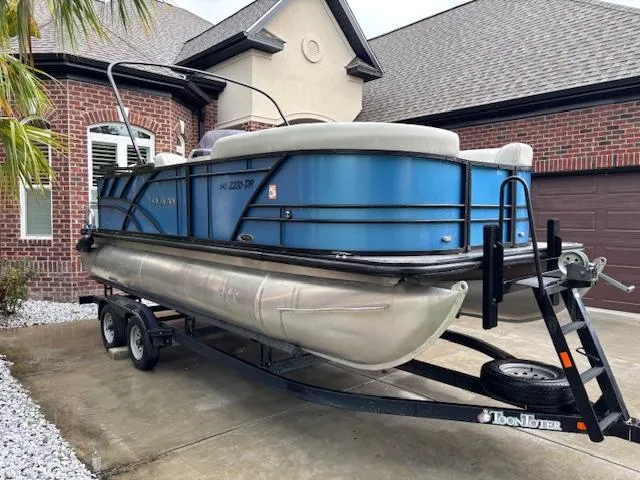 Slide: The Image of 2021 Sylvan Mirage 820 Cruise pontoon boat on trailer in residential driveway. - 2