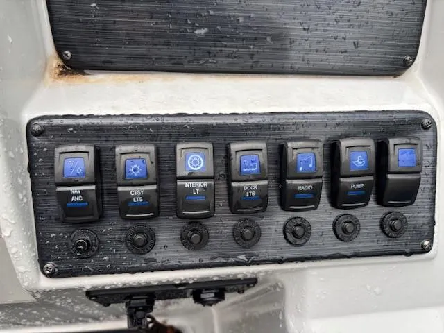Slide: The Image of Control panel of 2021 Sylvan Mirage 820 Cruise boat with various switches. - 23