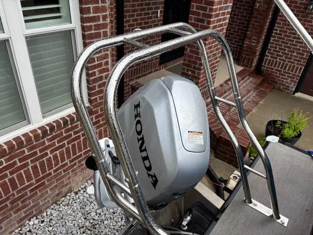 Slide: The Image of 2021 Sylvan Mirage 820 Cruise with Honda outboard motor, parked near brick building. - 24