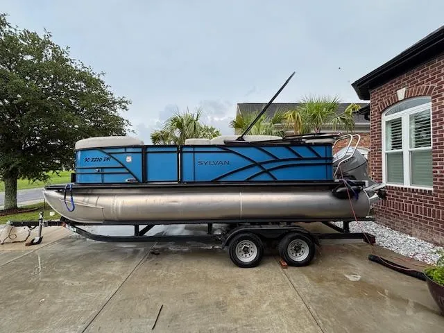Slide: The Image of 2021 Sylvan Mirage 820 Cruise pontoon boat on trailer, parked in driveway. - 3