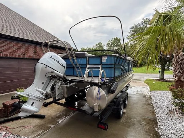 Slide: The Image of 2021 Sylvan Mirage 820 Cruise pontoon boat with Honda outboard motor on a trailer. - 6