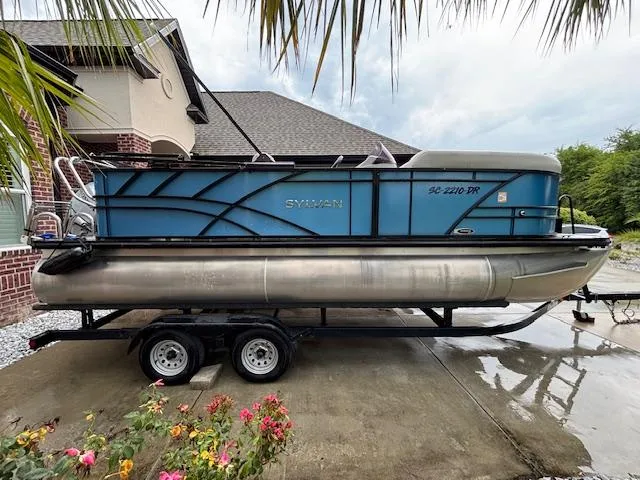 Slide: The Image of 2021 Sylvan Mirage 820 Cruise pontoon boat on trailer, parked in driveway. - 7