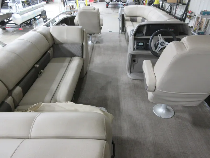 Slide: The Image of 2024 Sun Tracker SportFish 20 DLX interior with beige seating and steering console. - 10