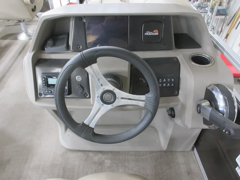 Slide: The Image of 2024 Sun Tracker SportFish 20 DLX dashboard with steering wheel and control panel. - 11