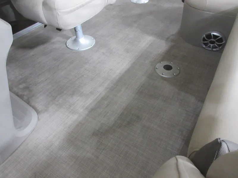 Slide: The Image of 2024 Sun Tracker SportFish 20 DLX interior with beige seating and carpeted flooring. - 14