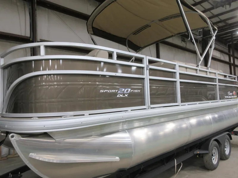 Slide: The Image of 2024 Sun Tracker SportFish 20 DLX pontoon boat in a showroom setting. - 3