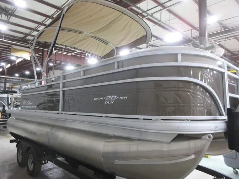 Slide: The Image of 2024 Sun Tracker SportFish 20 DLX pontoon boat in a showroom setting. - 4