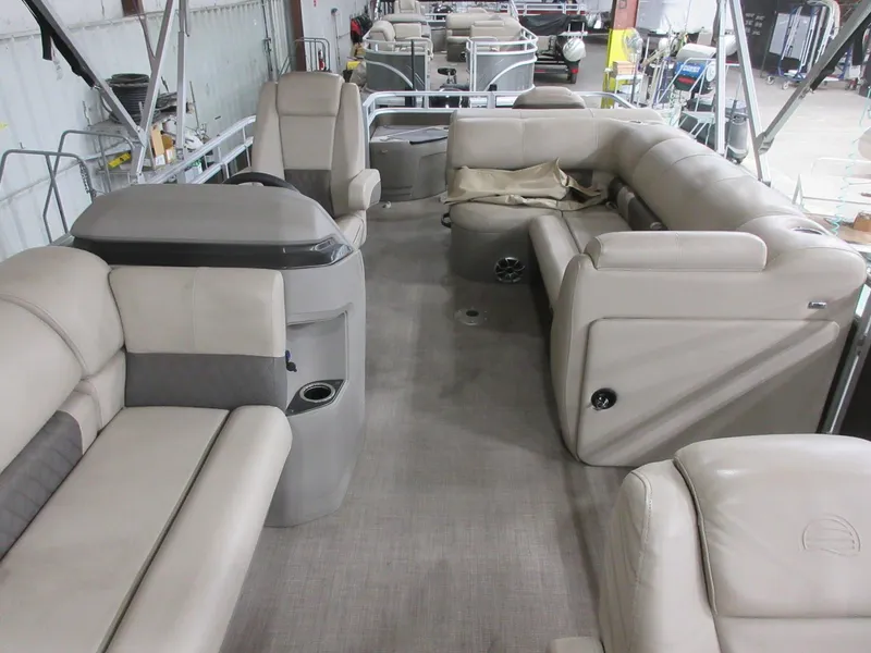 Slide: The Image of 2024 Sun Tracker SportFish 20 DLX pontoon boat interior with beige seating and spacious layout. - 9