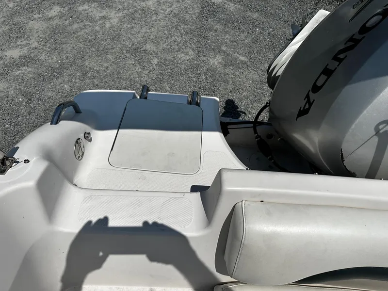 Slide: The Image of 2002 Godfrey Hurricane SD187 boat with Honda outboard motor on gravel surface. - 10