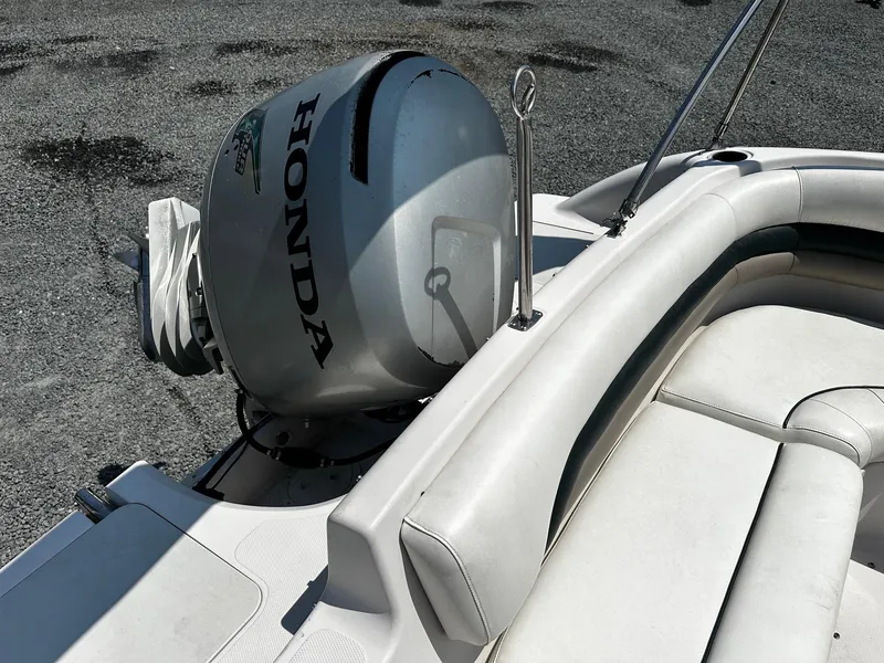 Slide: The Image of 2002 Godfrey Hurricane SD187 boat with Honda outboard motor, white seating, and metal railings. - 11