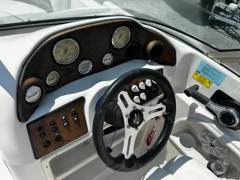 Slide: The Image of 2002 Godfrey Hurricane SD187 boat dashboard with steering wheel and control panel. - 3