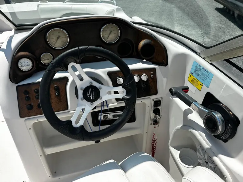Slide: The Image of Steering console of a 2002 Godfrey Hurricane SD187 boat with gauges and controls. - 4