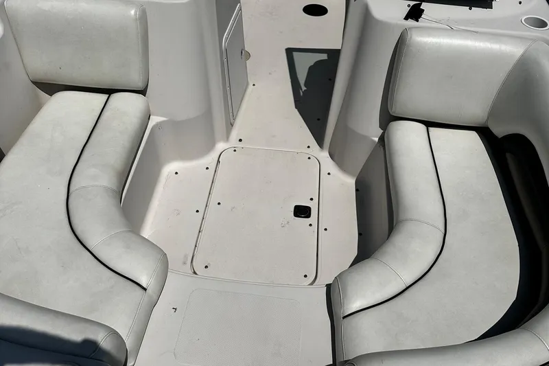 Slide: The Image of Interior seating of a 2002 Godfrey Hurricane SD187 boat, featuring white cushioned seats. - 8