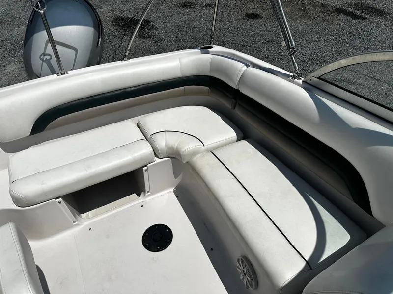 Slide: The Image of 2002 Godfrey Hurricane SD187 boat interior with white seating and storage compartment. - 9