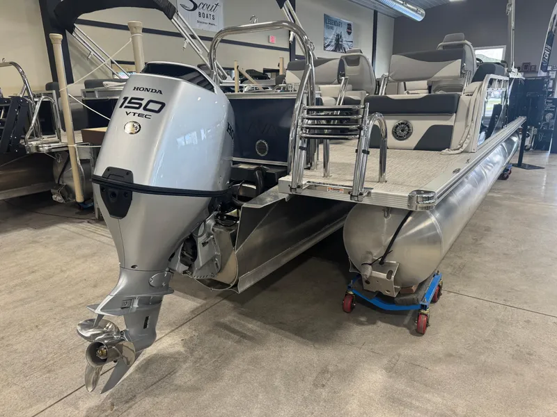 Slide: The Image of 2025 Avalon LSZ Quad Lounger Shift pontoon boat with Honda 150 VTEC engine in showroom. - 11