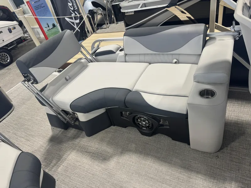 Slide: The Image of 2025 Avalon LSZ Quad Lounger Shift boat seating with cup holder and speaker, in showroom. - 9