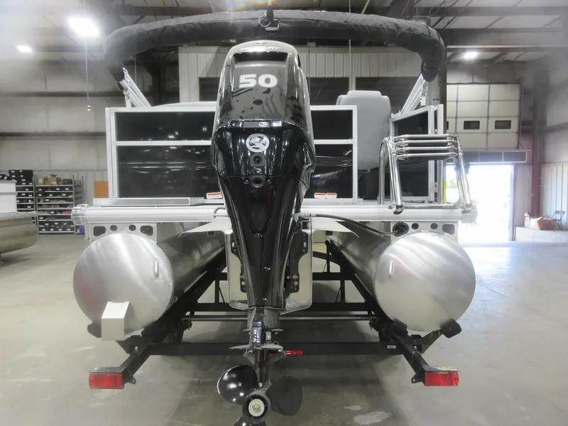 Slide: The Image of 2026 Sun Tracker Party Barge 16 DLX pontoon boat with 50 HP engine in a warehouse. - 3