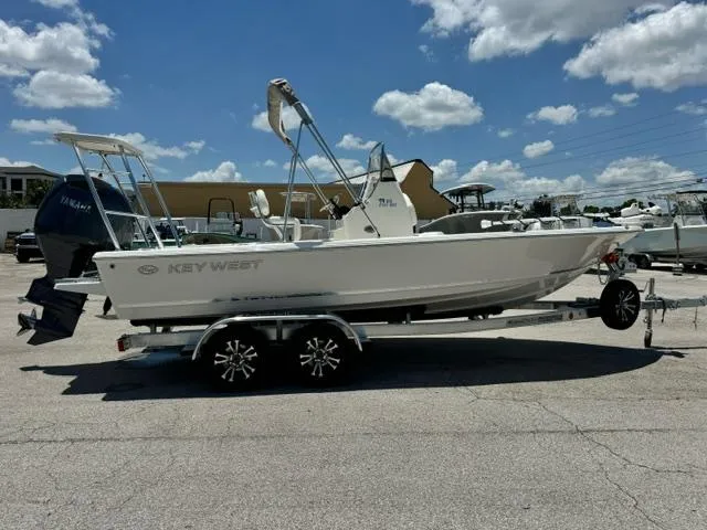 Slide: The Image of 2026 Key West 210 Bay Reef boat on trailer under blue sky. - 5