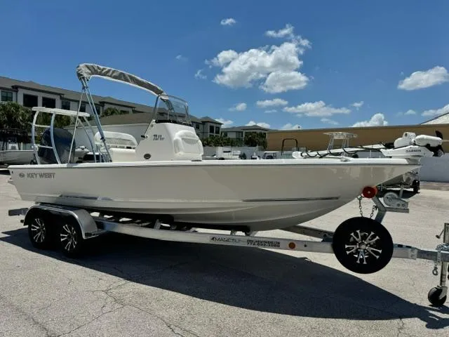 Slide: The Image of 2026 Key West 210 Bay Reef boat on trailer under clear blue sky. - 6