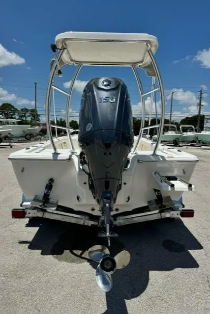 Slide: The Image of 2026 Key West 210 Bay Reef boat with powerful outboard motor, parked on a sunny day. - 7