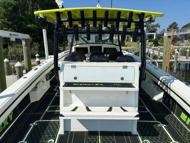 Slide: The Image of 2020 Prowler 42 boat with vibrant green accents docked at a marina. - 16